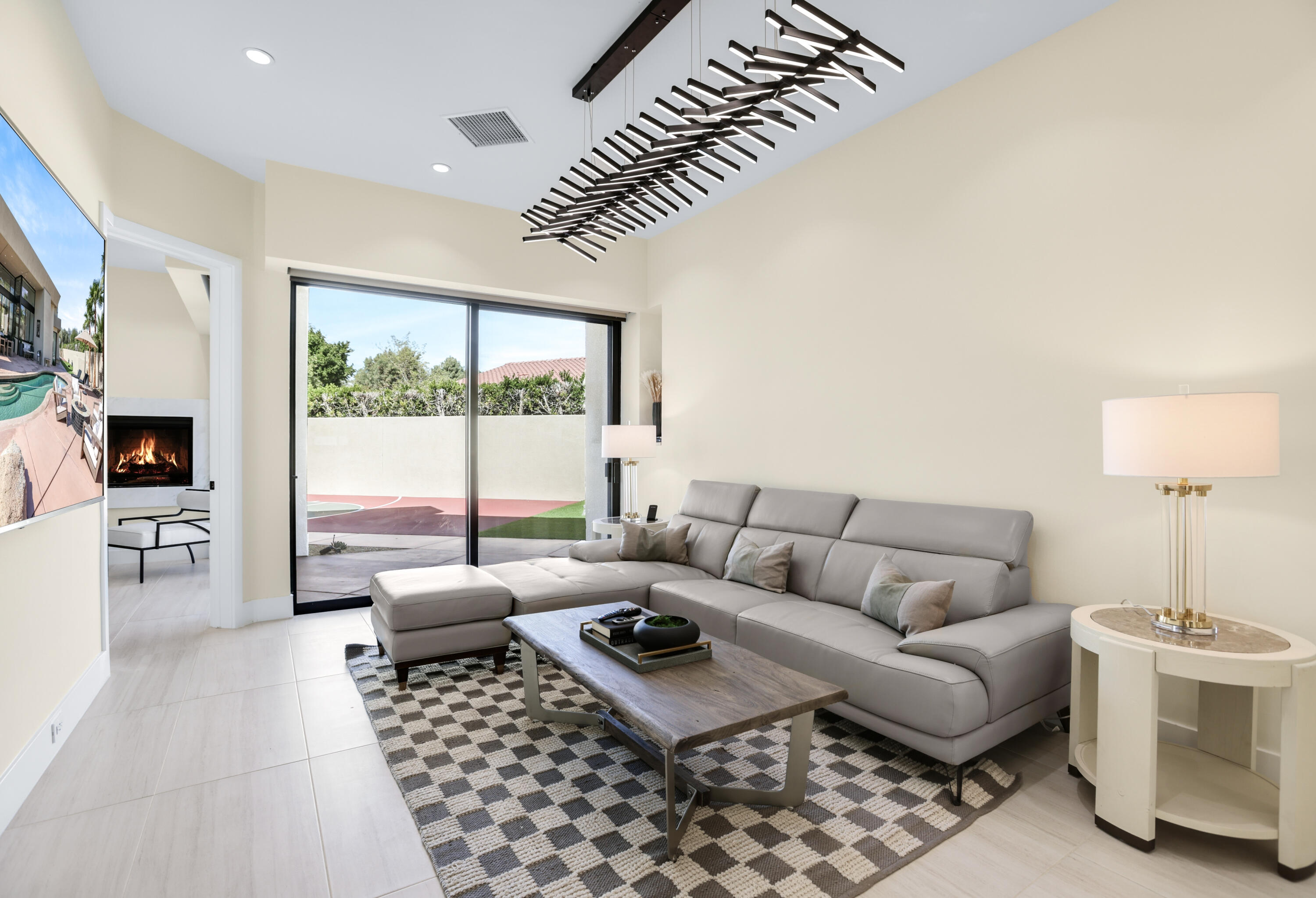 1 Seclude Court Rancho Mirage, CA 92270 - Photo 39 of 52 a living room with furniture a flat screen tv and a fireplace