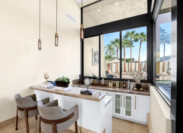 a kitchen with a large window and chairs