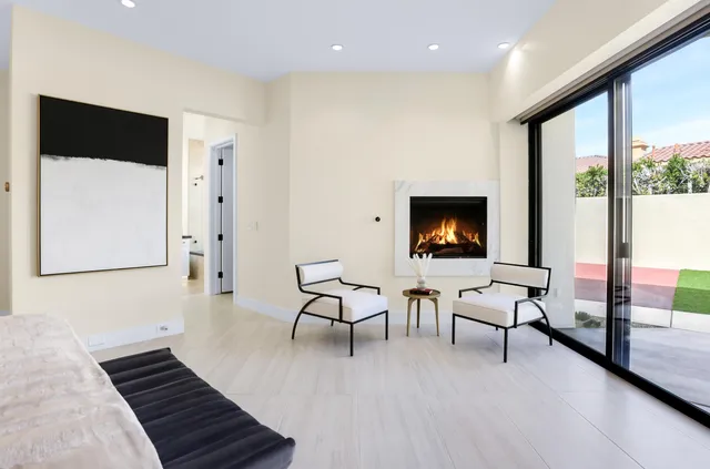 a dining table with chairs and a potted plant