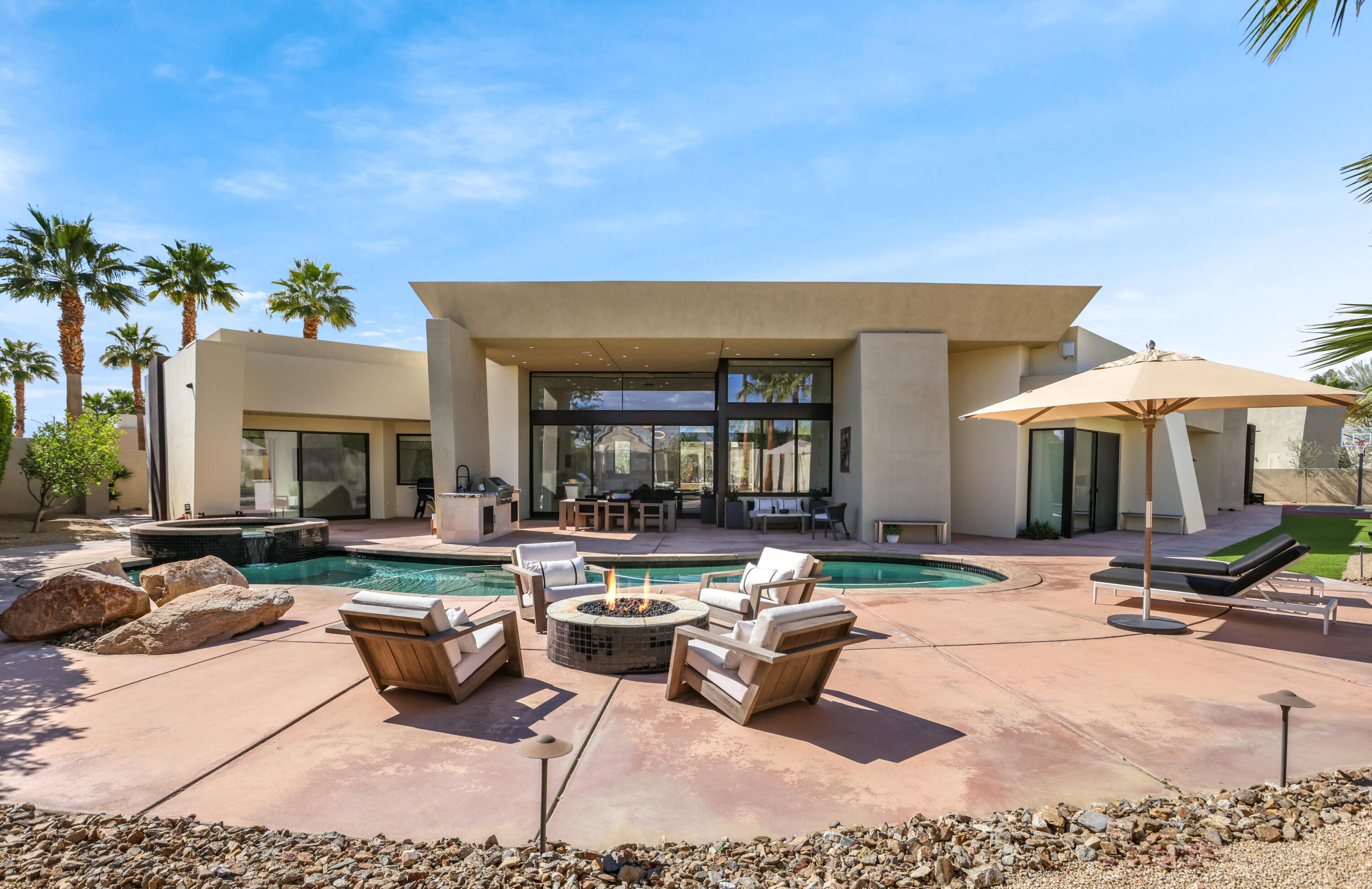 1 Seclude Court Rancho Mirage, CA 92270 - Photo 49 of 52 a view of a house with swimming pool and sitting area