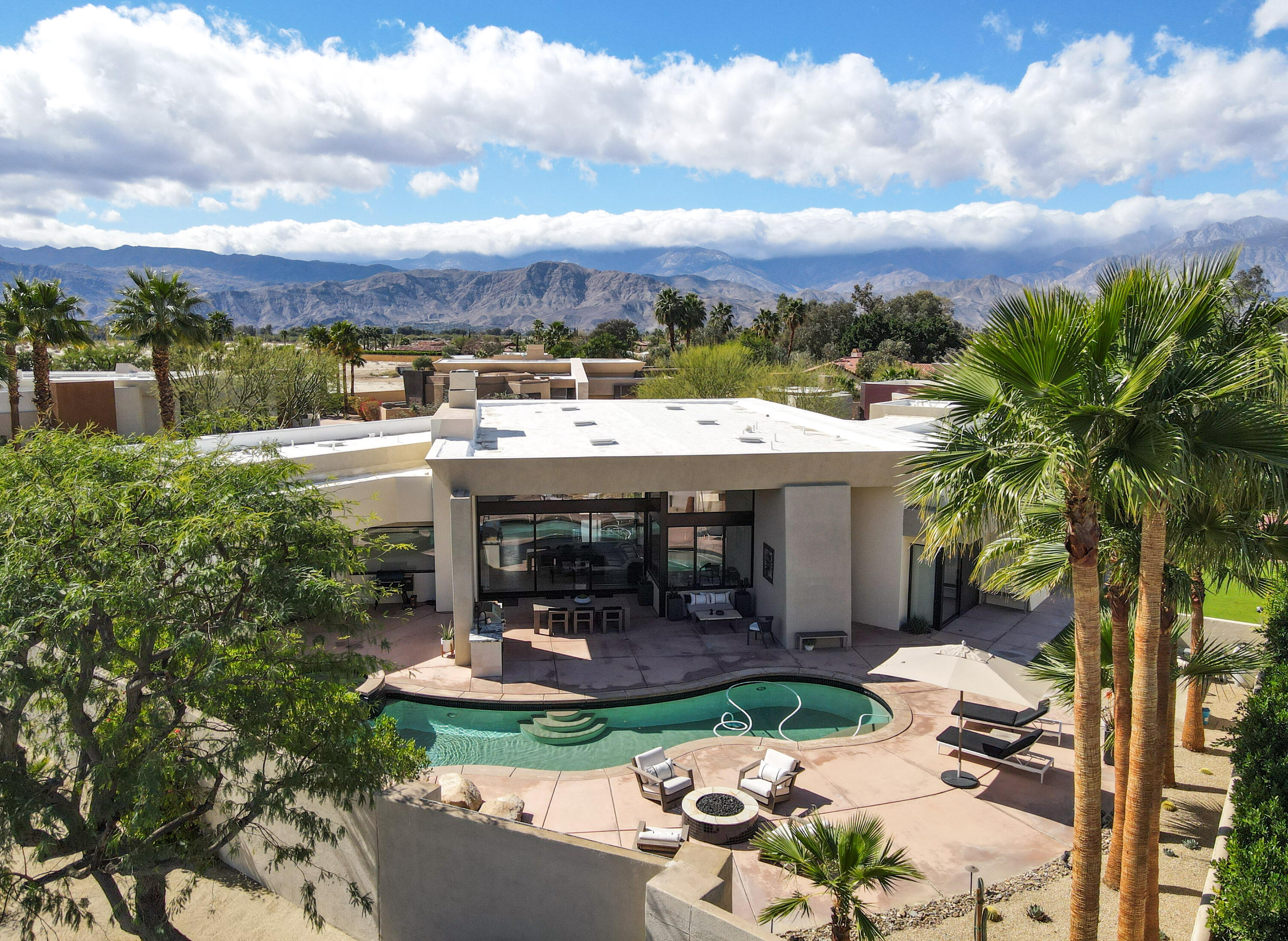 1 Seclude Court Rancho Mirage, CA 92270 - Photo 52 of 52 a view of a patio with table and chairs and a fire pit