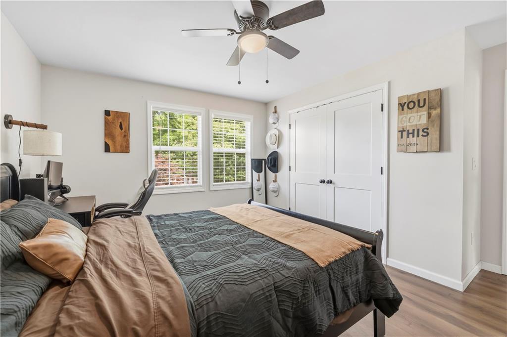 156 Pine Avenue Commerce, GA 30529 - Photo 9 of 35 a bedroom with a bed and wooden floor