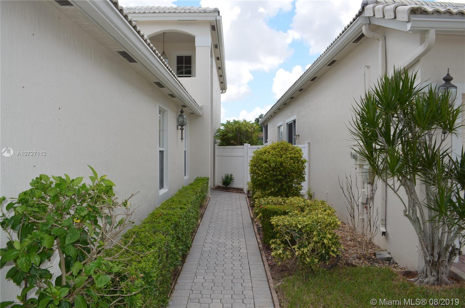 6334 Brava Way Boca Raton, FL 33433 - Photo 21 of 41 WALKWAY TO COVERED FRONT PORCH