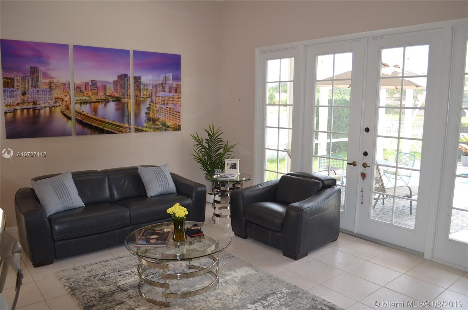 6334 Brava Way Boca Raton, FL 33433 - Photo 23 of 41 LIVING ROOM ADJACENT TO KITCHEN