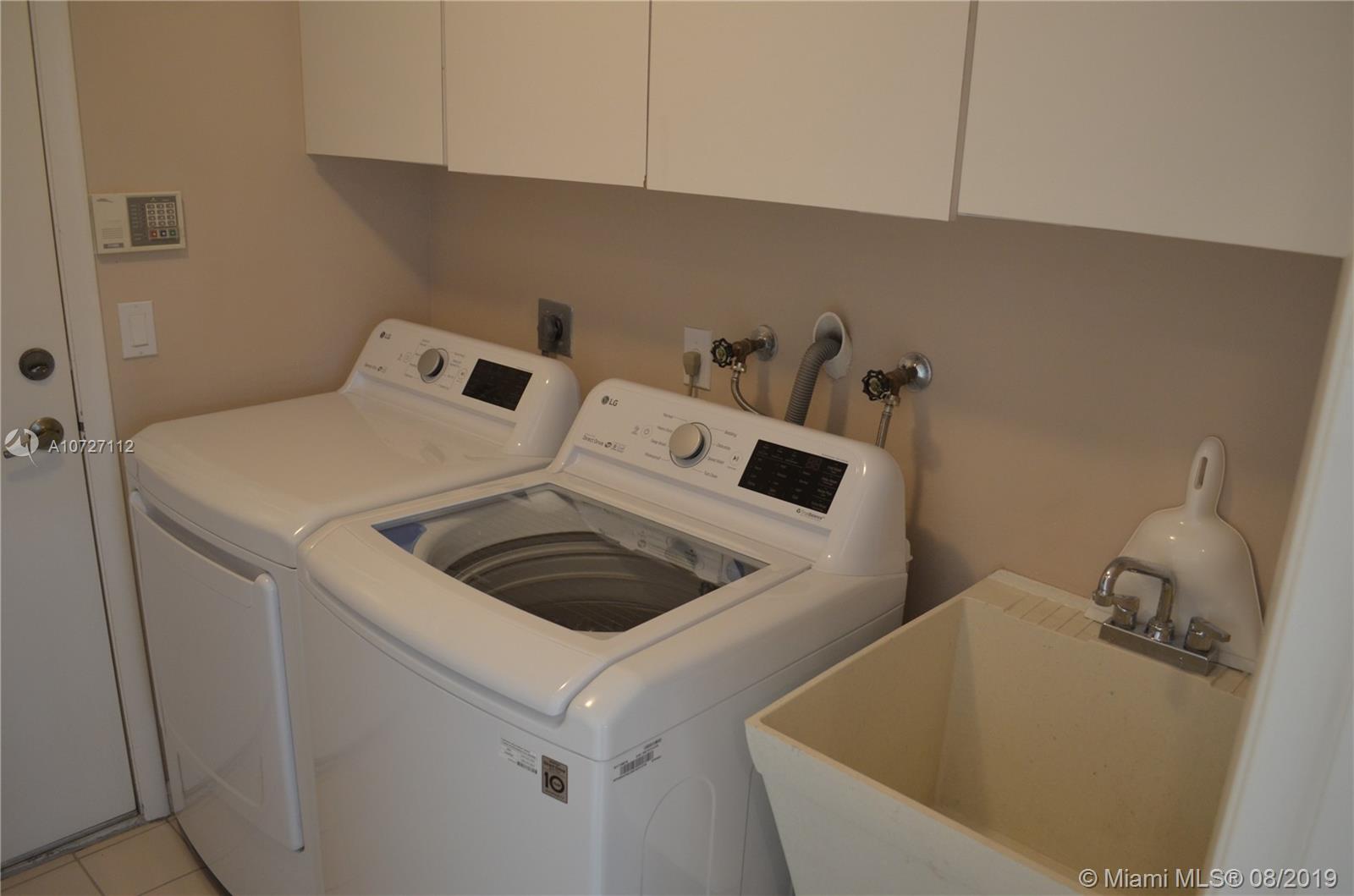 6334 Brava Way Boca Raton, FL 33433 - Photo 27 of 41 LAUNDRY ROOM WITH BRAND NEW WASHER/DRYER, SINK AND FOLDING AREA.
