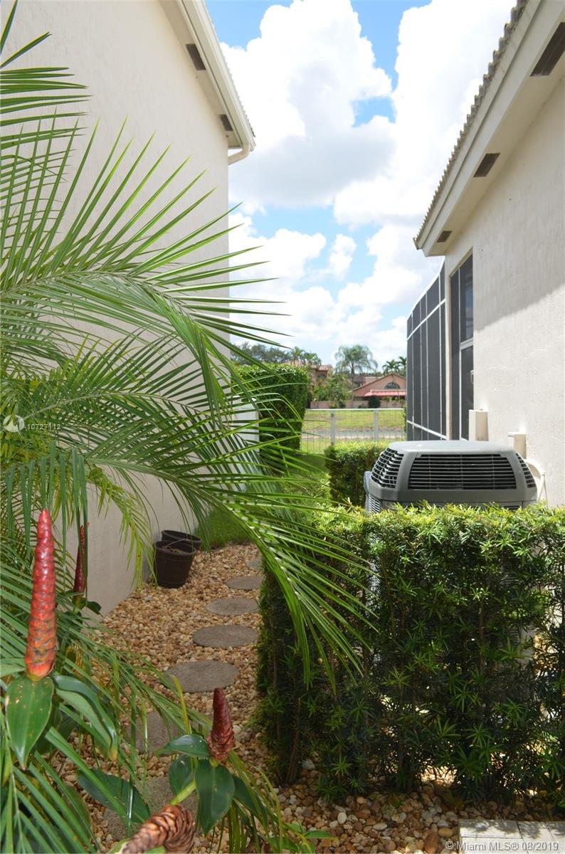 6334 Brava Way Boca Raton, FL 33433 - Photo 40 of 41 WALKWAY FROM KITCHEN NOOK PATIO TO SCREENED IN POOL