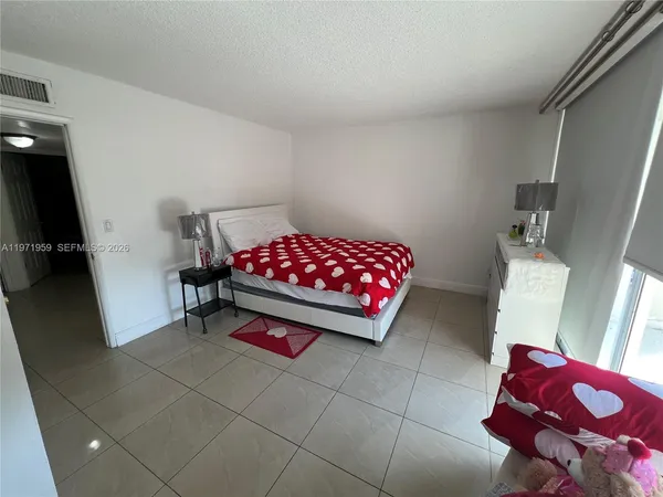a bedroom with a bed and a rug