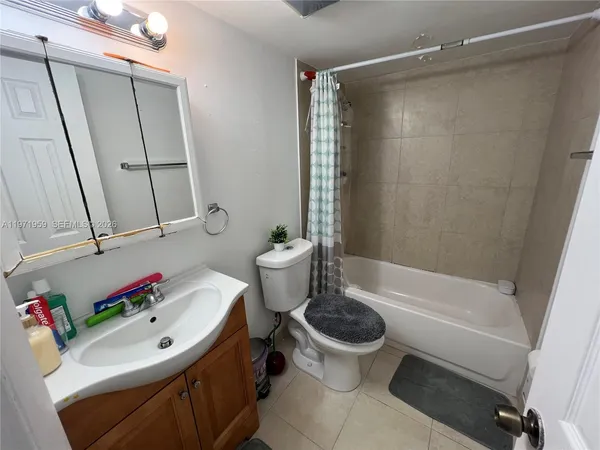 a view of an empty room and bathroom