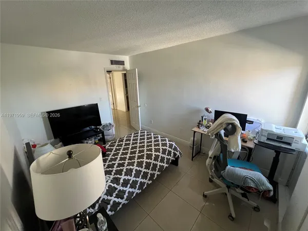 a kitchen with a sink a refrigerator and cabinets
