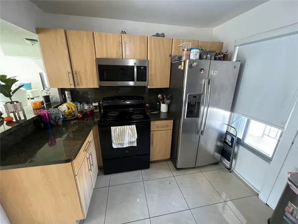 a kitchen with granite countertop a sink and a stove
