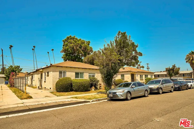 a group of cars parked in front of a house