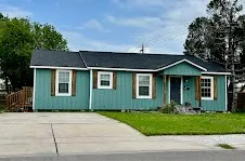a front view of a house with a garden