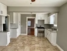 a kitchen with granite countertop a stove and a refrigerator