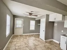 a view of a livingroom with an empty space and a window