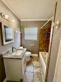 a bathroom with a granite countertop sink a mirror and shower