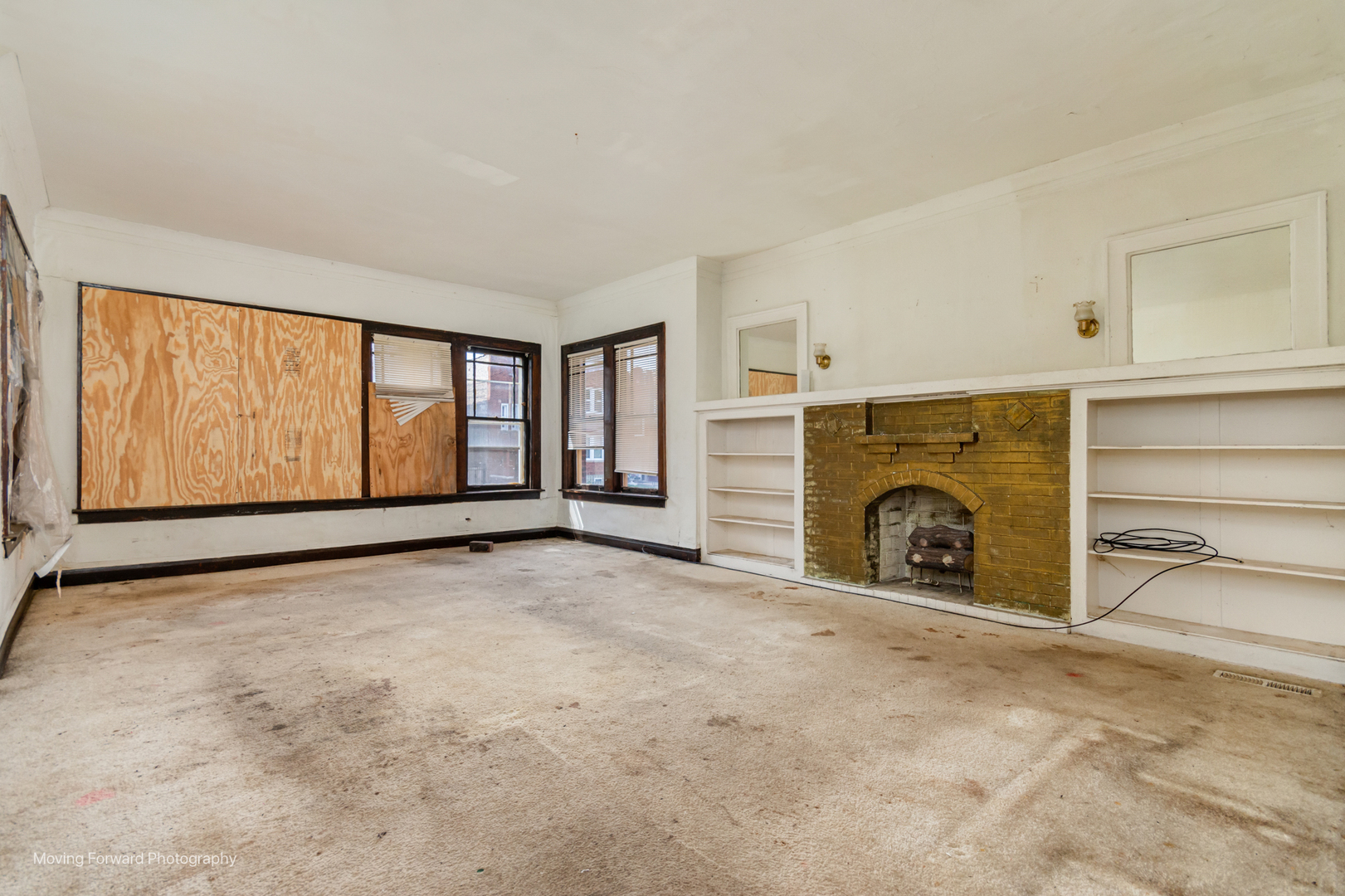 8153 South Sangamon Street Chicago, IL 60620 - Photo 12 of 37 a view of an empty room with a fireplace and a window