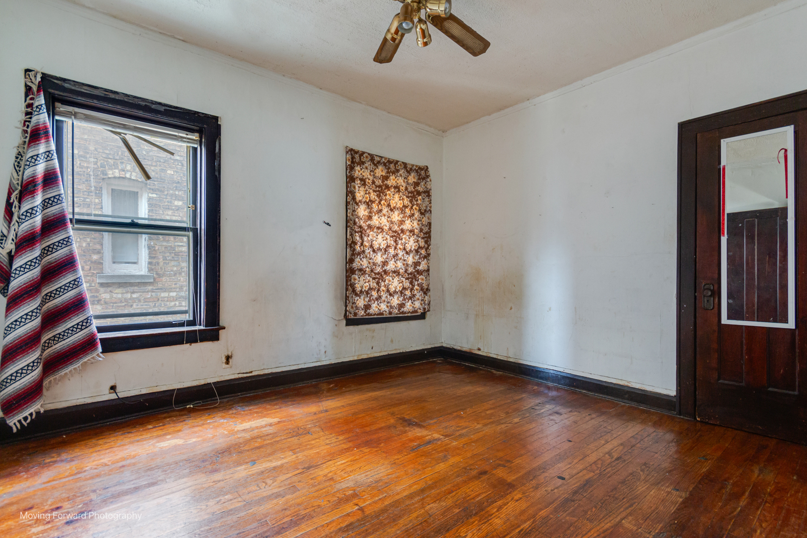 8153 South Sangamon Street Chicago, IL 60620 - Photo 23 of 37 a view of an empty room with a window and wooden floor