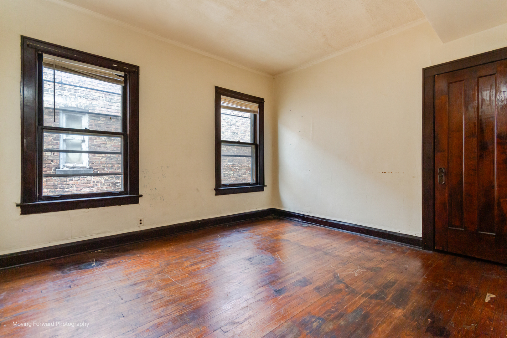 8153 South Sangamon Street Chicago, IL 60620 - Photo 28 of 37 an empty room with wooden floor and windows