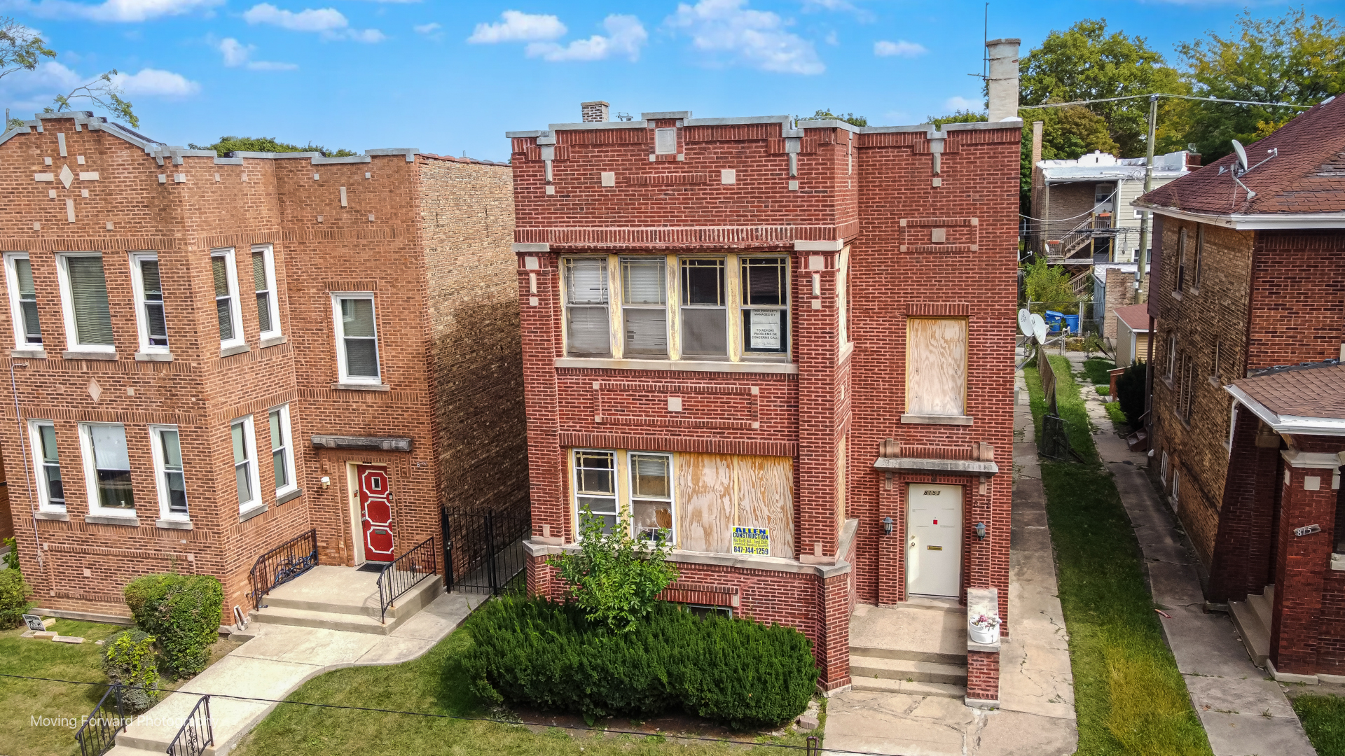 8153 South Sangamon Street Chicago, IL 60620 - Photo 7 of 37 a front view of a multi story residential apartment building with a yard