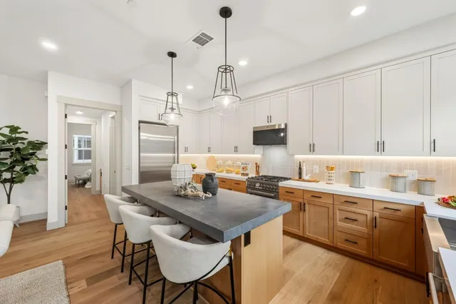 a kitchen with a table chairs sink and cabinets