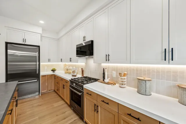 a kitchen with a sink stove and refrigerator