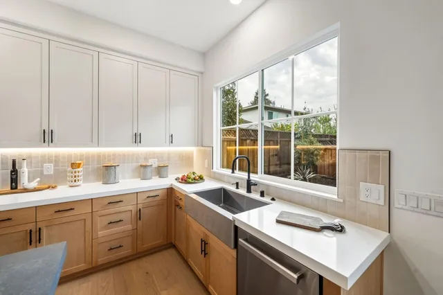 a kitchen with a sink stove and cabinets