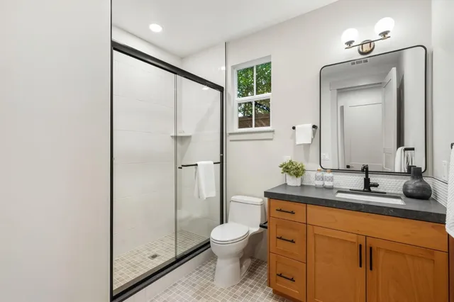 a bathroom with a toilet sink and shower