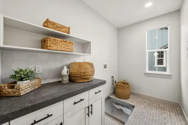a kitchen with stainless steel appliances granite countertop a sink and a white cabinets