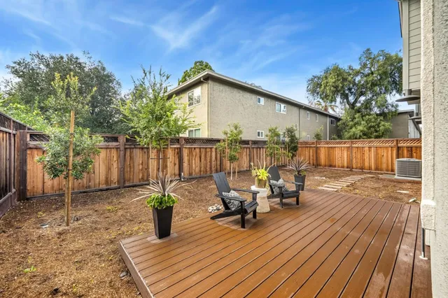 a view of a chairs and tables in the back yard of the house