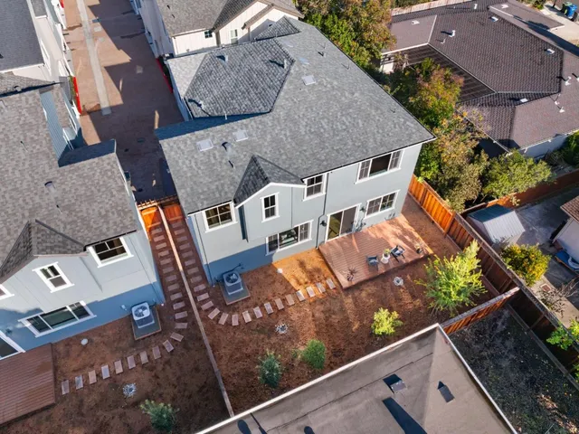 an aerial view of multiple houses with yard