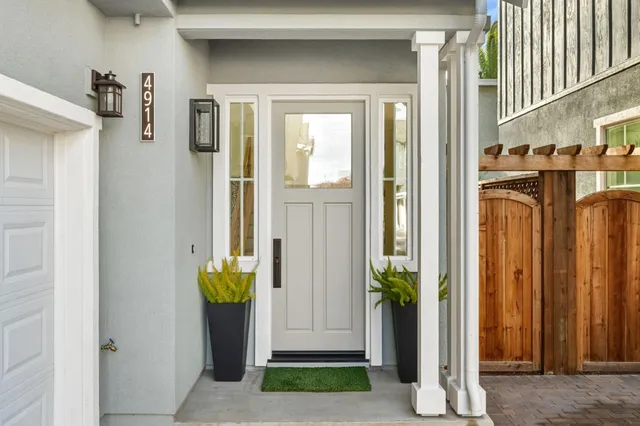 a front view of a house with a door and chair