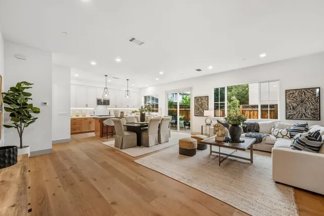 a living room with furniture stove and large window