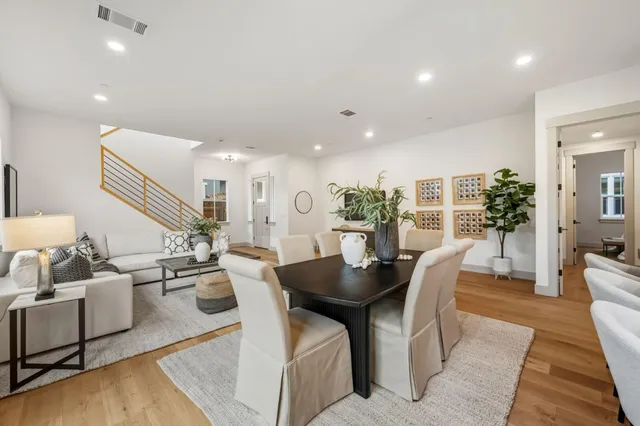 a dining room with furniture and wooden floor