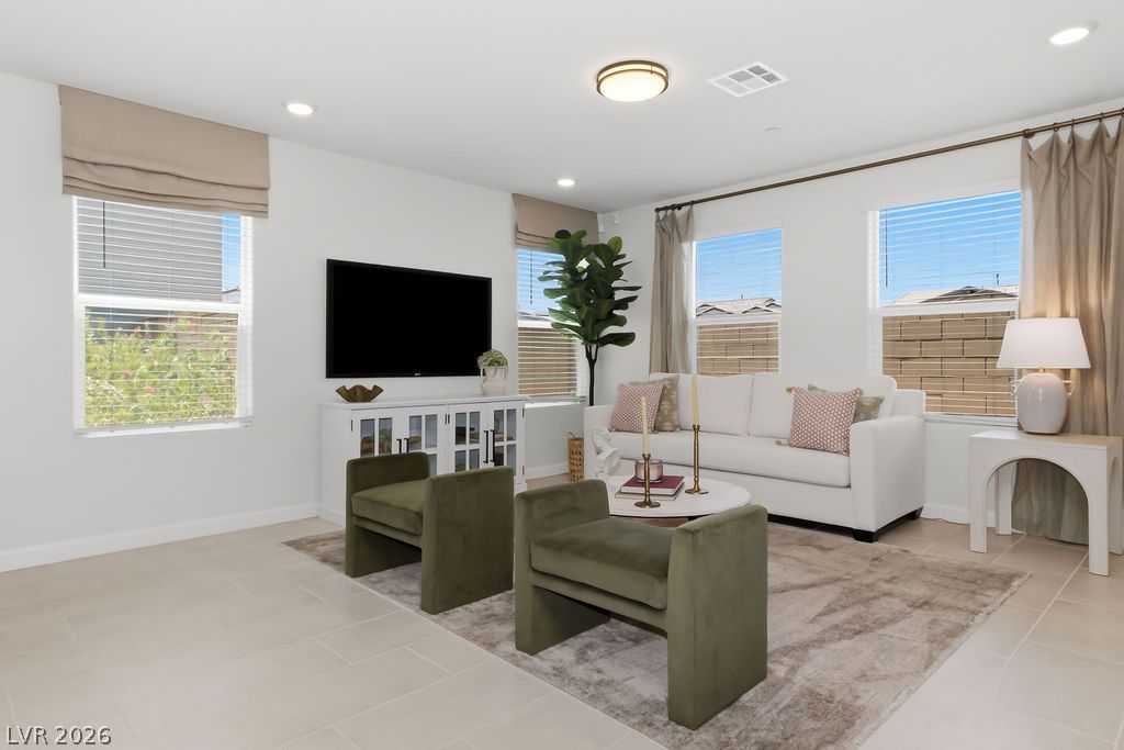 913 Cadence View Way Henderson, NV 89011 - Photo 12 of 46 Natural light filters into this generous living area, offering a comfortable atmosphere.