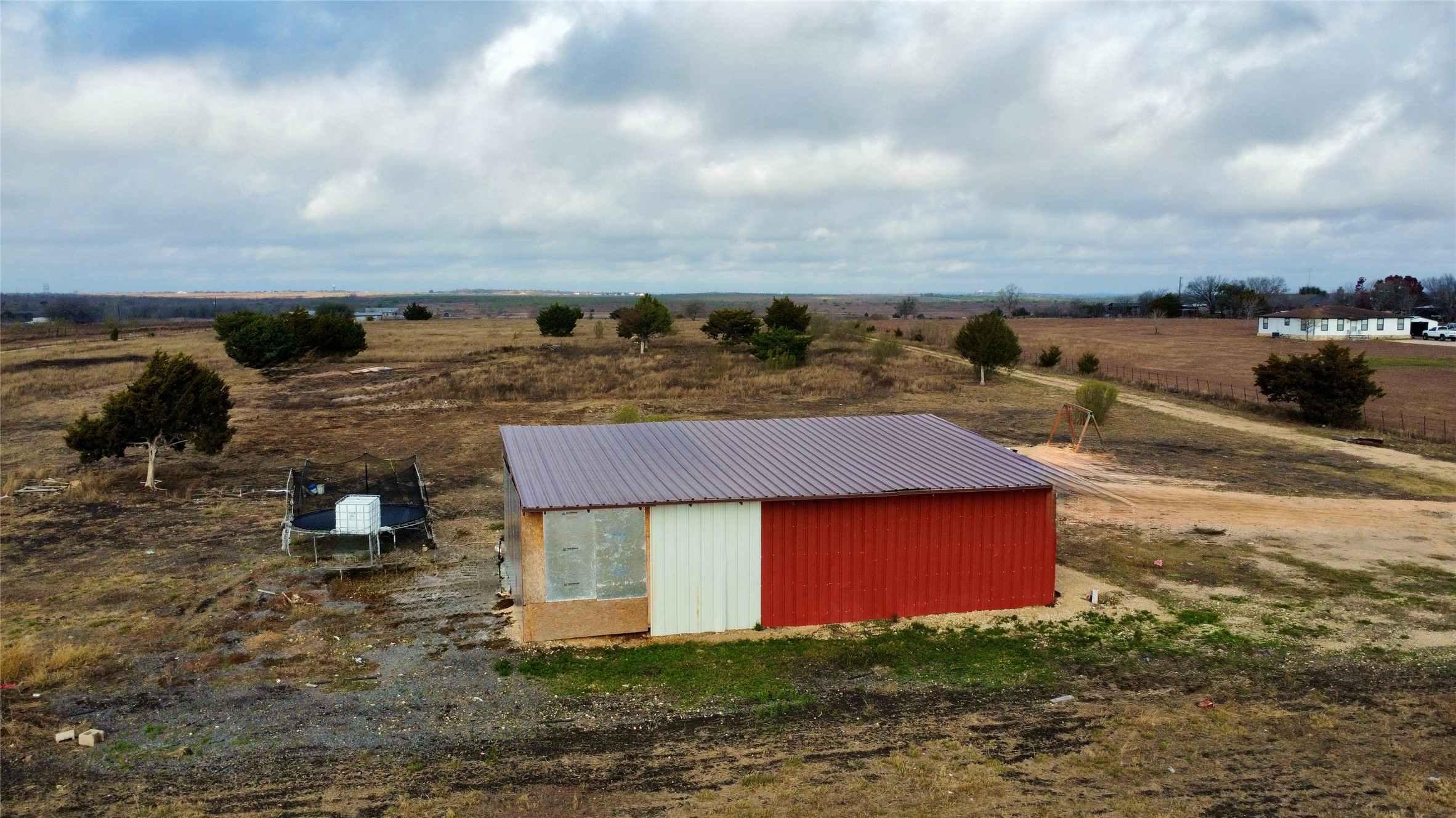 14024 Graef Road Buda, TX 78610 - Photo 2 of 12 View of pole building with a view of countryside