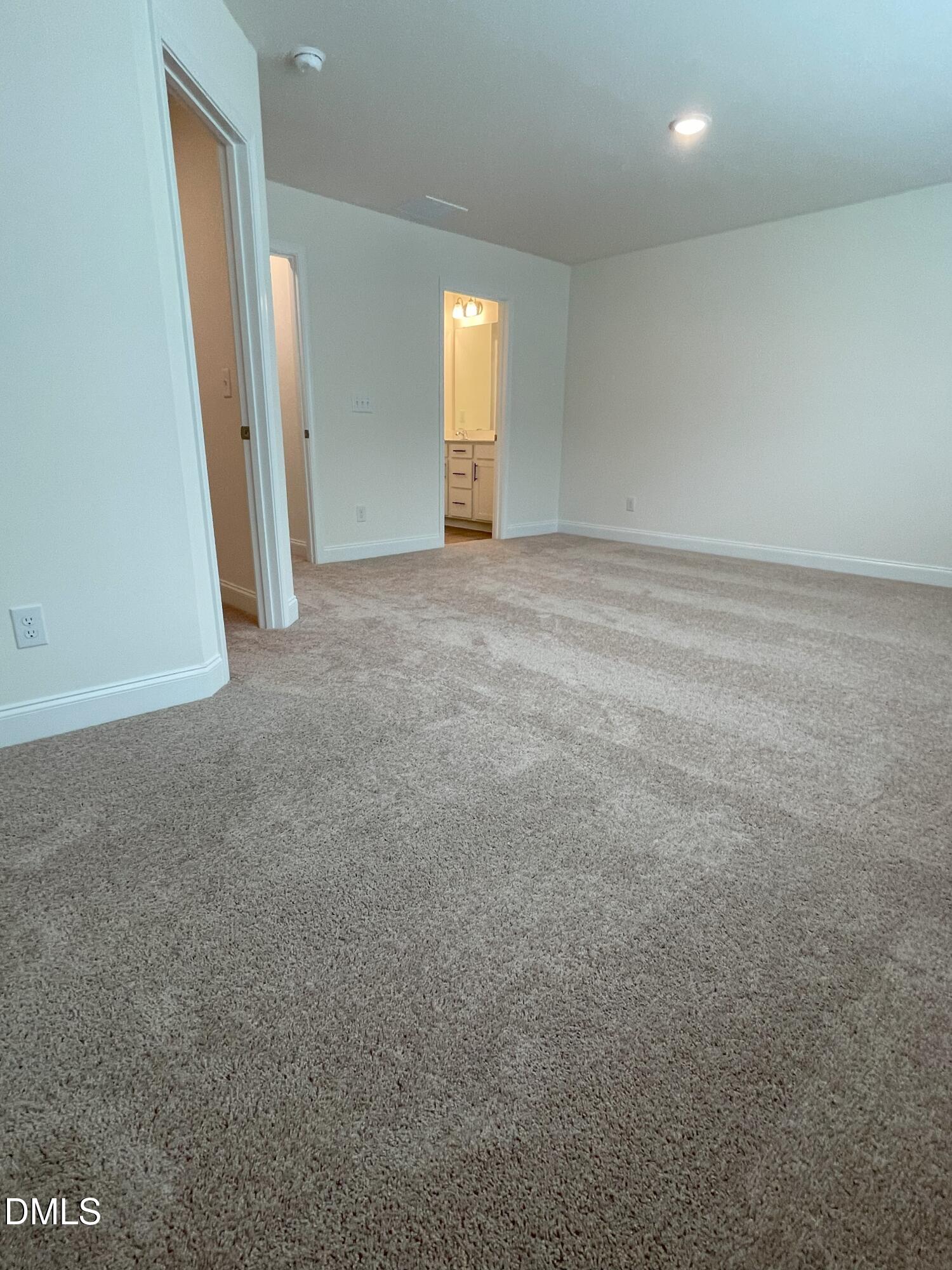 6404 Lady Eliza Lane Raleigh, NC 27610 - Photo 20 of 37 an empty room with staircase and mirror