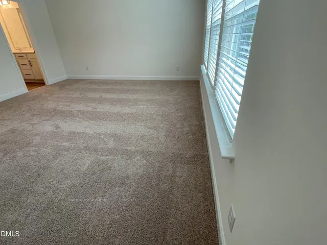 a view of an empty room with windows