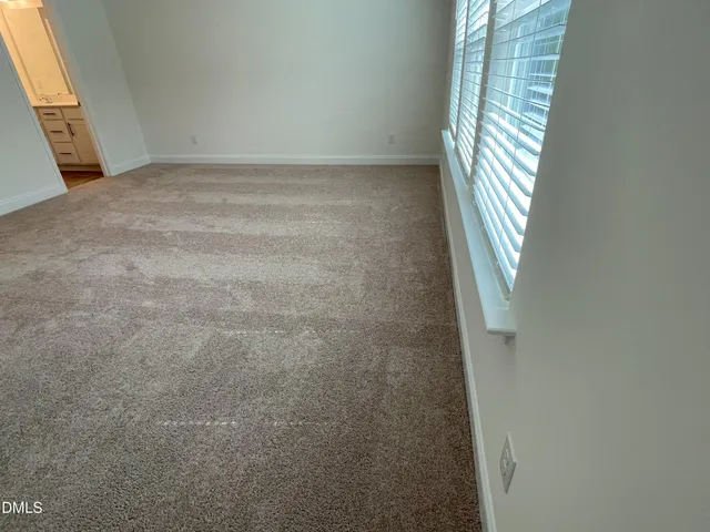 a view of an empty room with windows