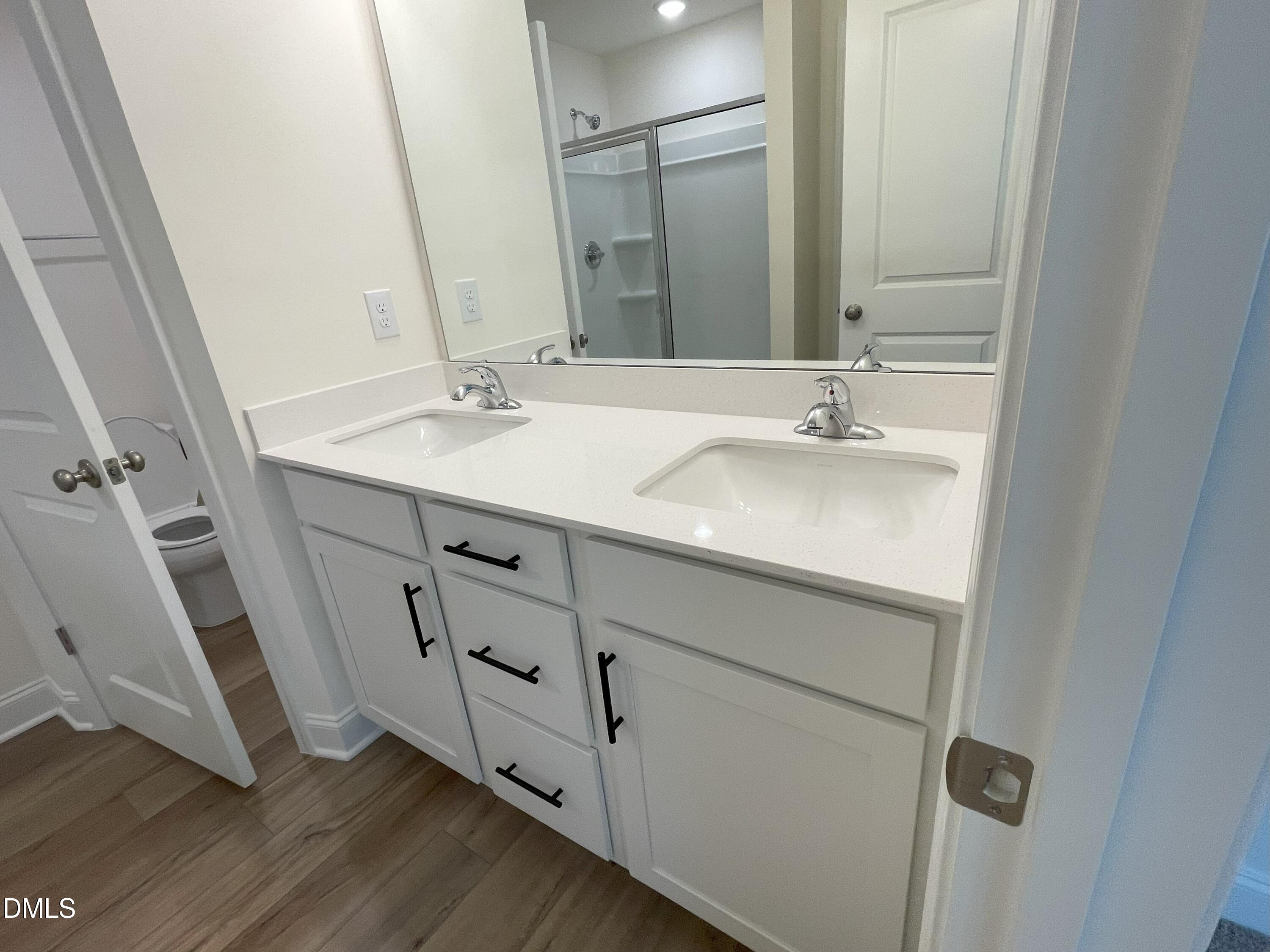 6404 Lady Eliza Lane Raleigh, NC 27610 - Photo 24 of 37 a bathroom with a double vanity sink and mirror