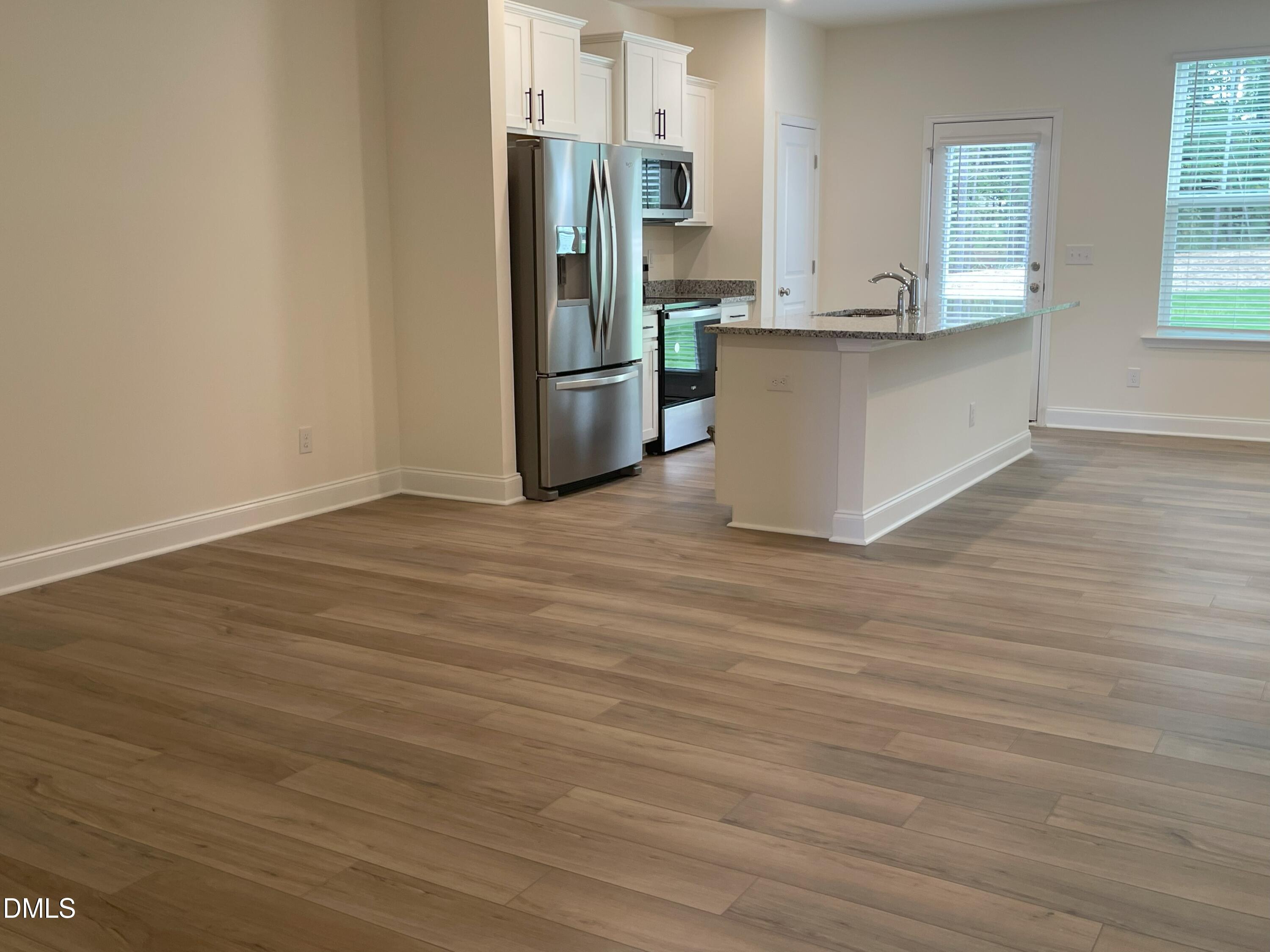 6404 Lady Eliza Lane Raleigh, NC 27610 - Photo 5 of 37 a kitchen with stainless steel appliances a refrigerator and a stove