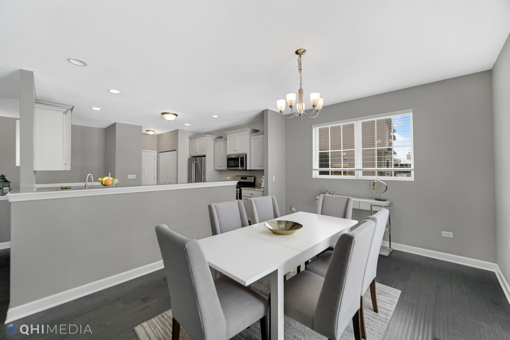 16432 Mueller Circle Plainfield, IL 60586 - Photo 5 of 22 a view of a dining room and livingroom with furniture wooden floor a rug a chandelier