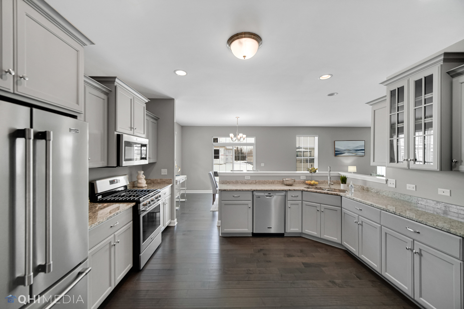 16432 Mueller Circle Plainfield, IL 60586 - Photo 9 of 22 a large kitchen with stainless steel appliances granite countertop a stove top oven a sink and dishwasher