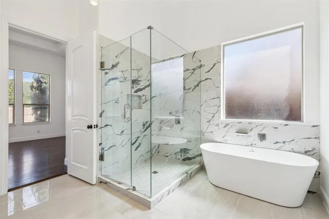 a bathroom with a bathtub and a shower