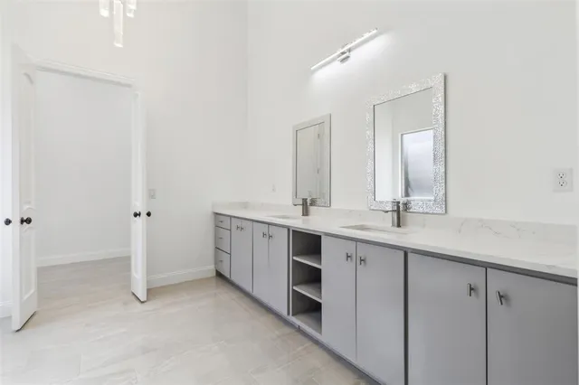 a bathroom with a double vanity sink and mirror