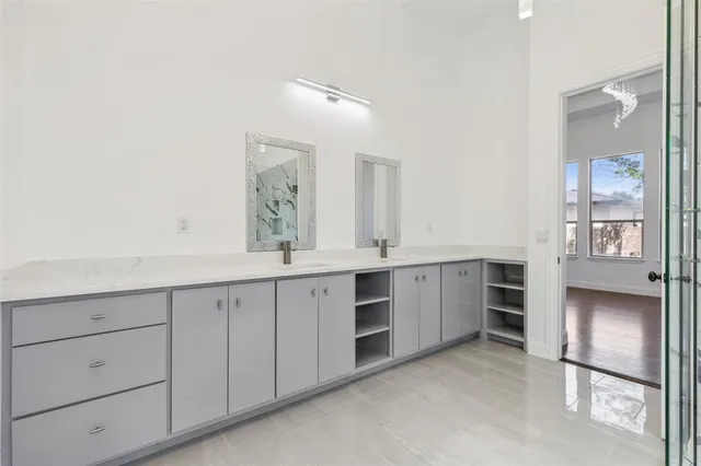 a spacious bathroom with a double vanity sink and a mirror