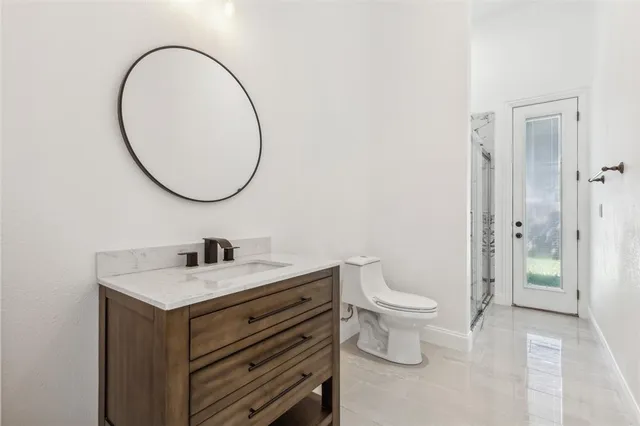 a bathroom with a sink a toilet and a mirror