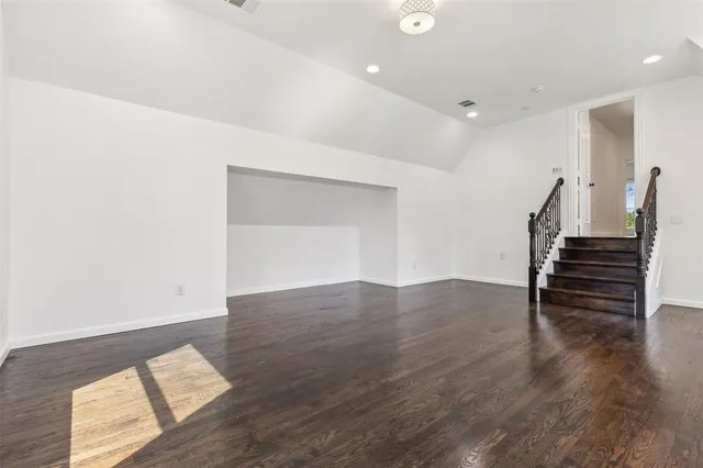 a view of wooden floor and windows in a room
