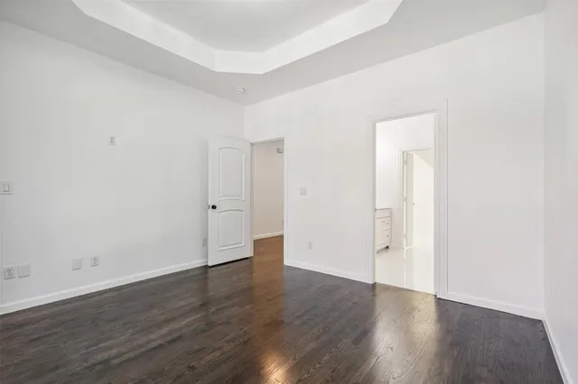 an empty room with wooden floor