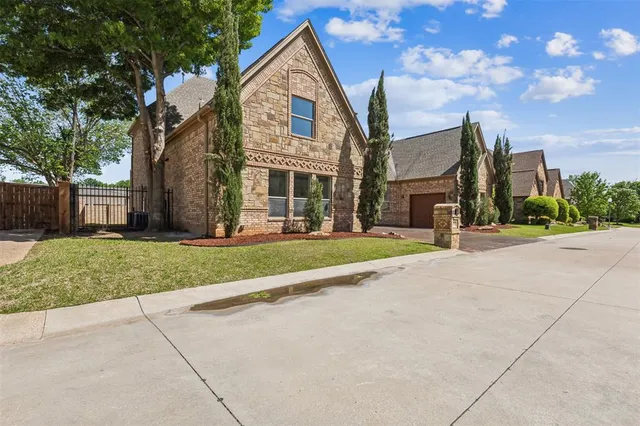 a view of a white house with a yard