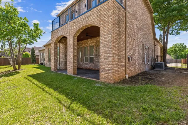 a view of a grey house with a yard